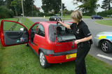 P1010550 Policewoman breaking window